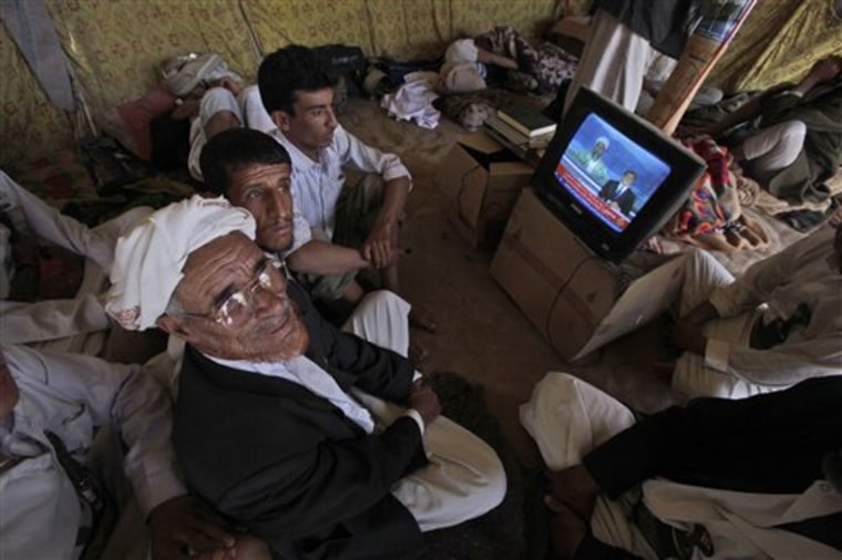 Anti-government protesters in Sanaa, Yemen, watch a TV broadcasting a report about the killing of Al-Qaida leader Osama bin Laden. They were in a tent at the site of a demonstration demanding the resignation of Yemeni President Ali Abdullah Saleh on Monday.